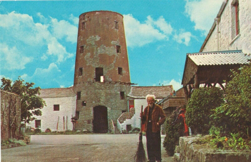 Gerald Gardner standing before the first Museum »The witches Mill« on the Isle of Man